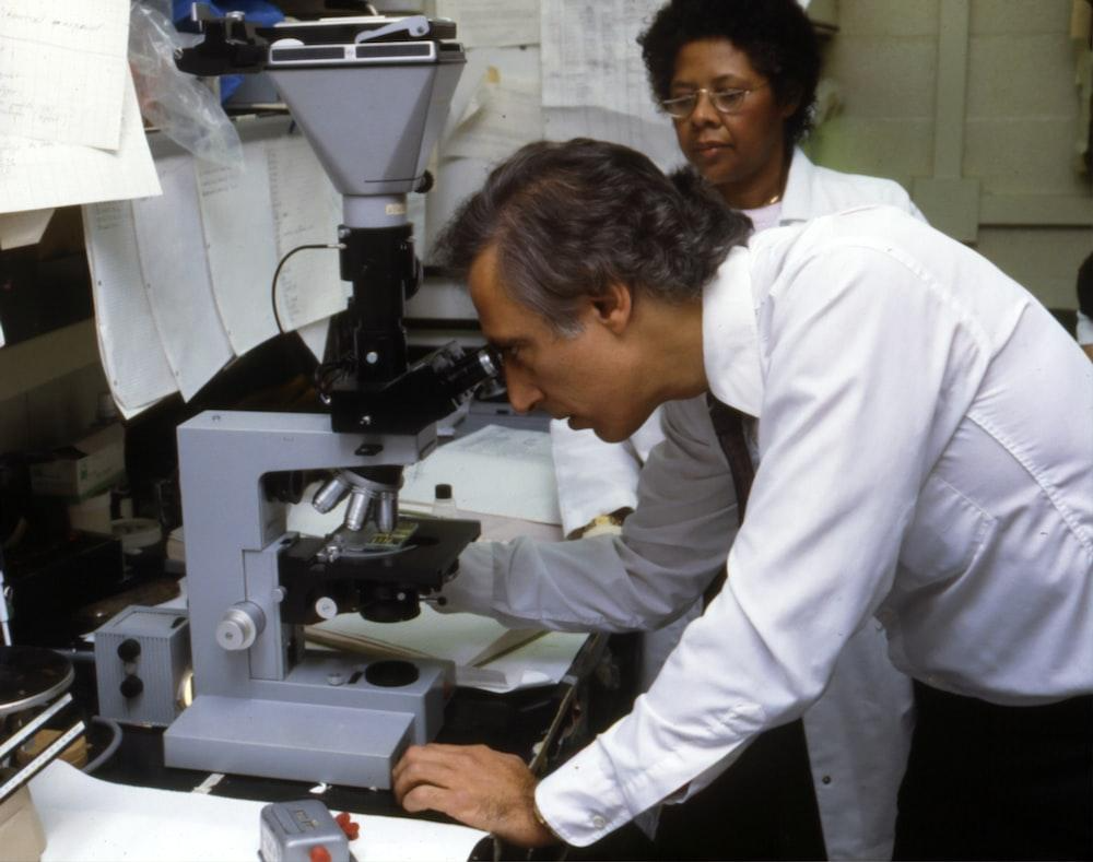 man using microscope